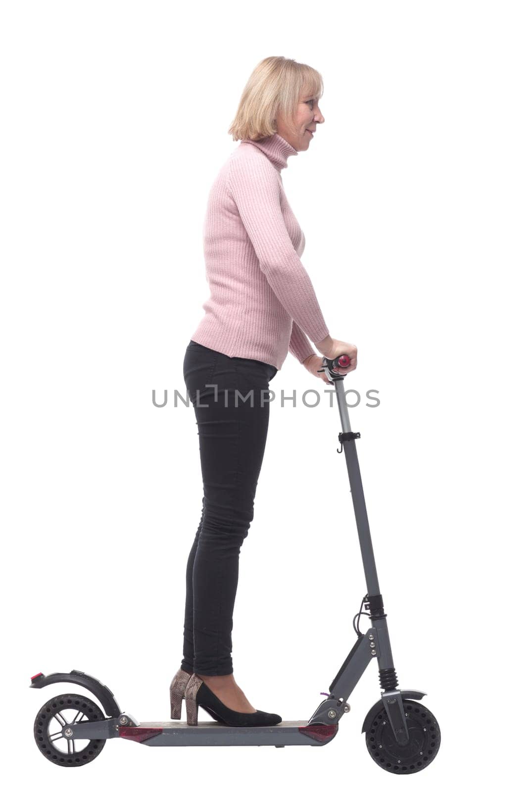 Beautiful woman riding an electric scooter isolated on white background and looking at camera and smiling