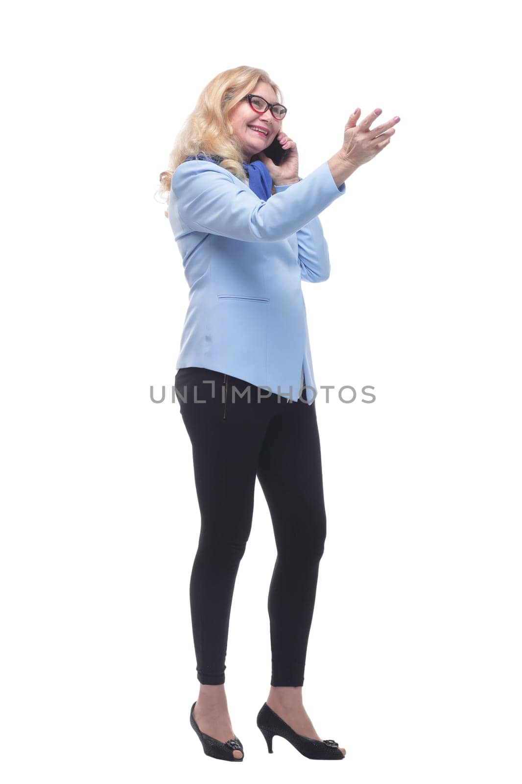 full-length. friendly casual woman with a smartphone . isolated on a white background.