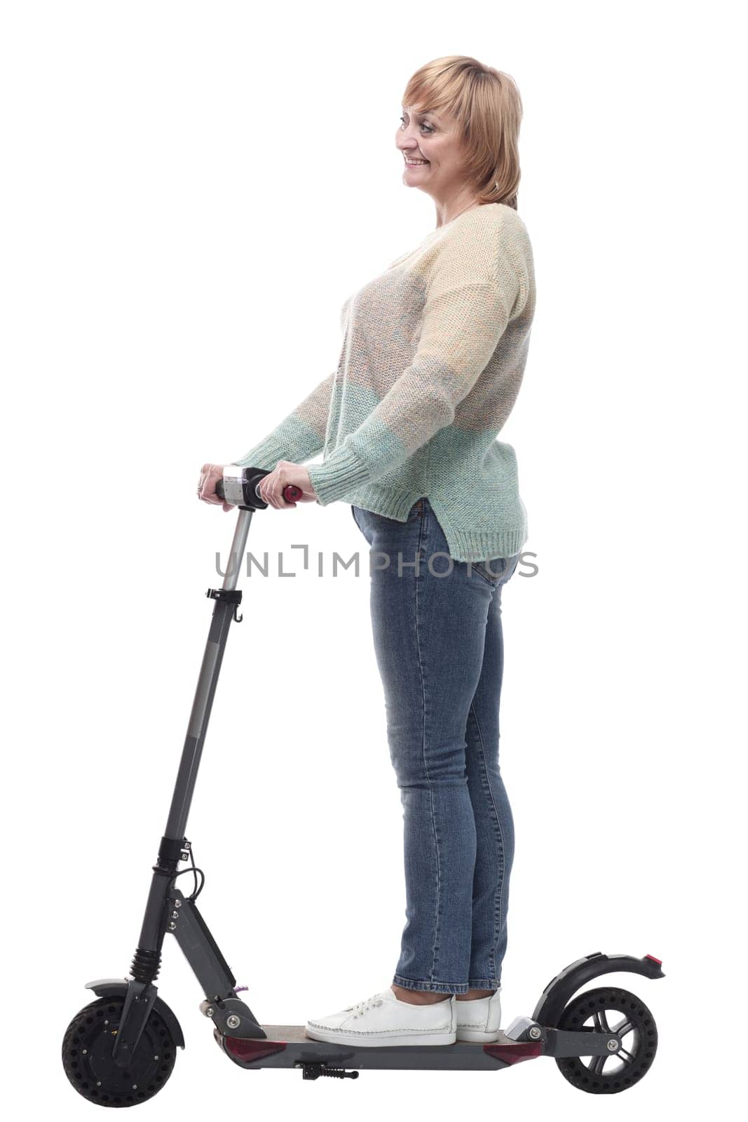 in full growth. attractive casual woman with electric scooter. isolated on a white background.