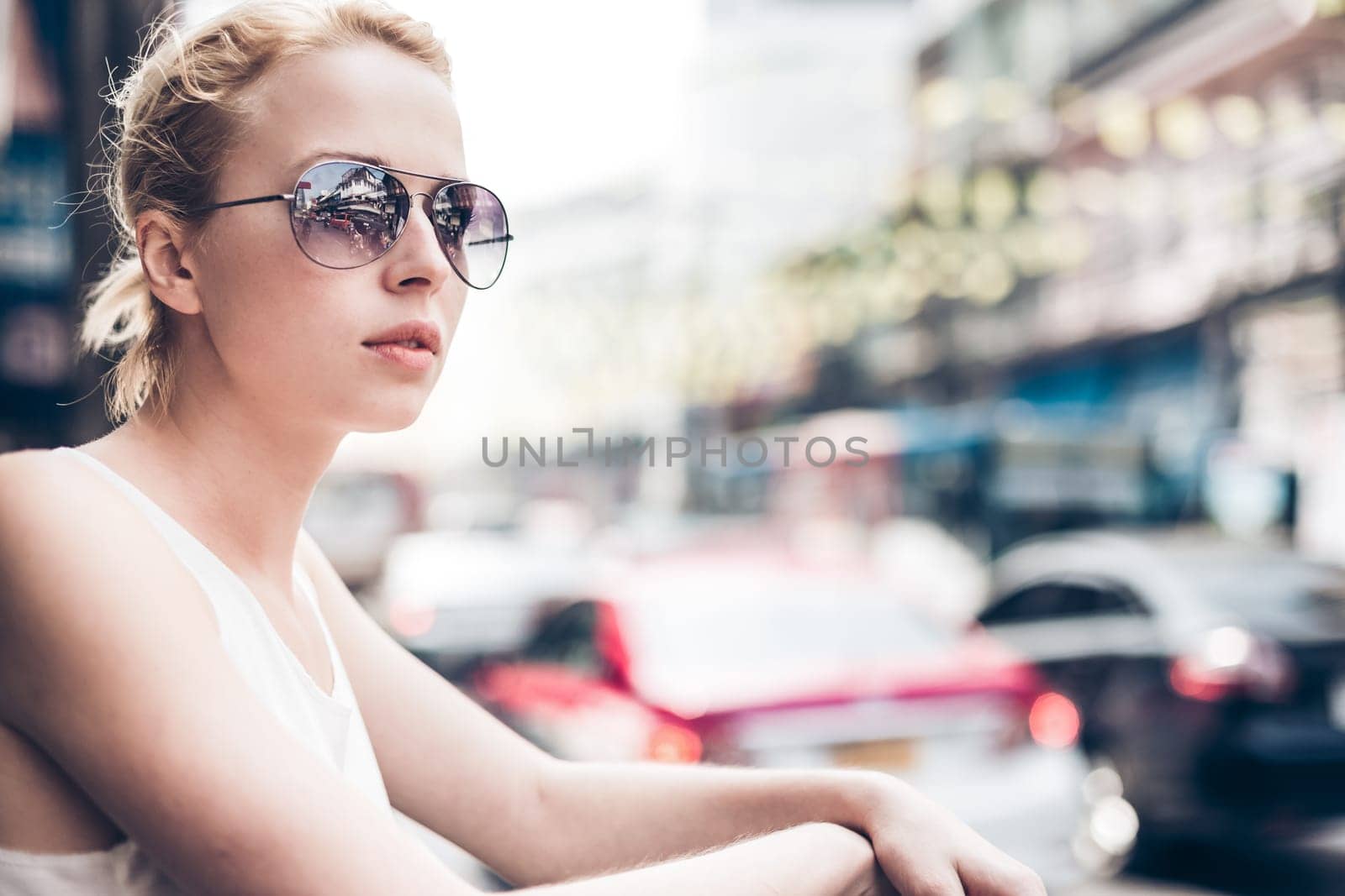 Portrait of Caucasian, Blonde, Female Traveler on the street of Bangkok, Thailand. Street shot.