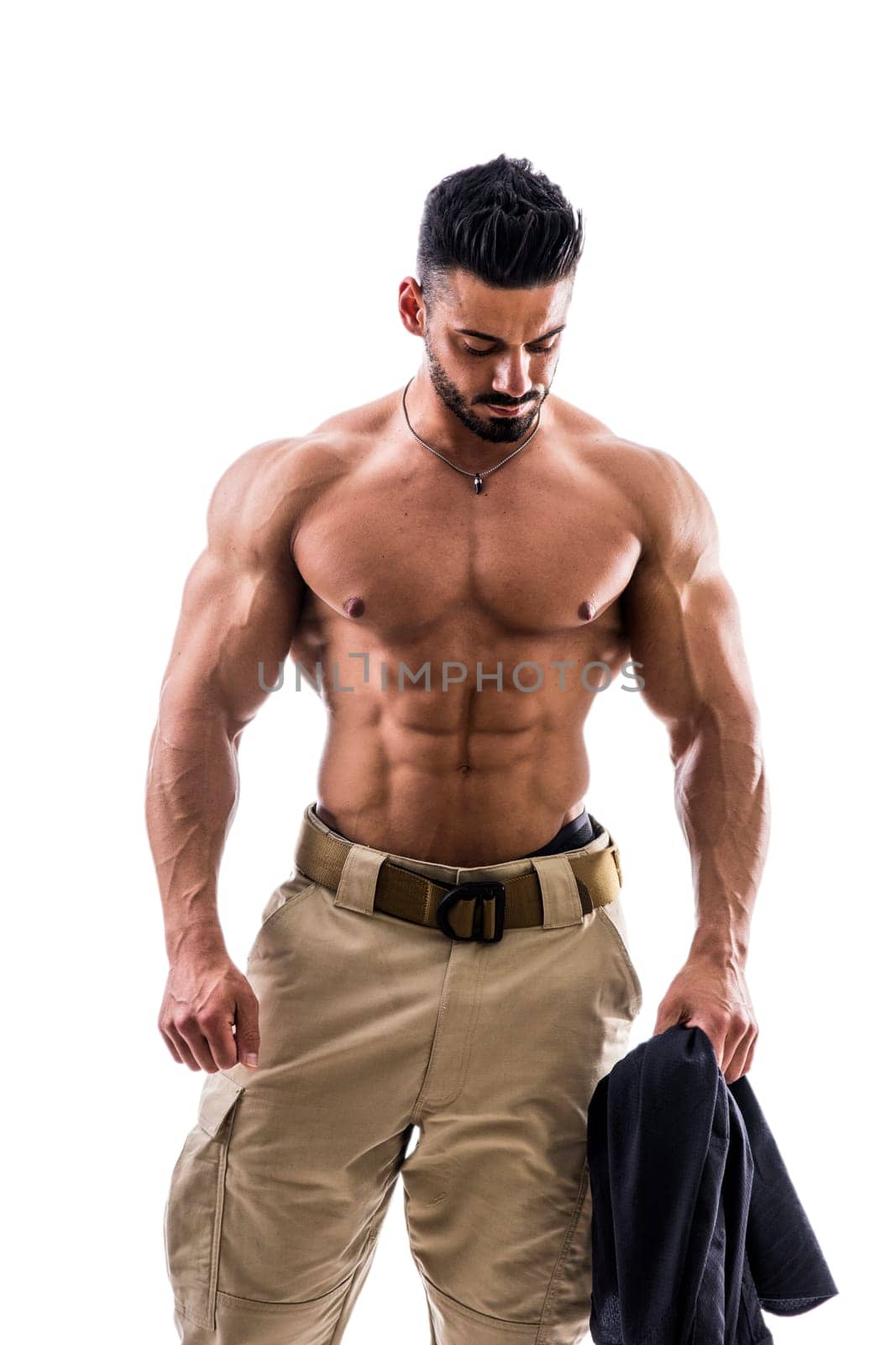 A shirtless man with no shirt holding a jacket, isolated on white in studio