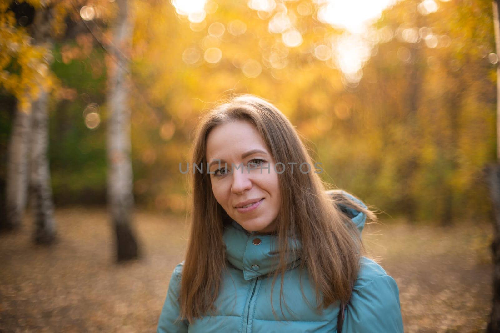 Autumn portrait of beautiful woman on fall nature background