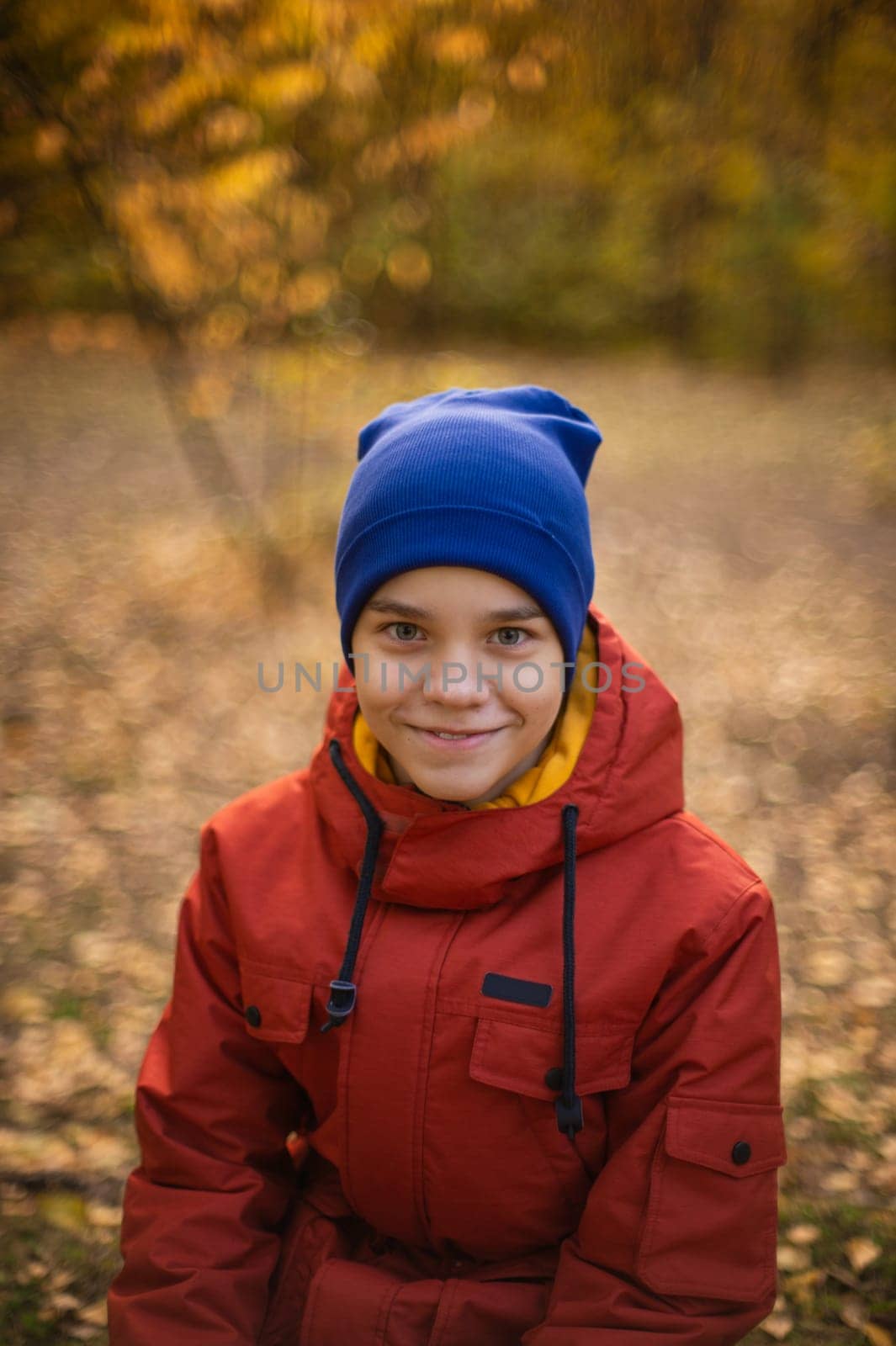 Autumn portrait of boy teen on fall nature background