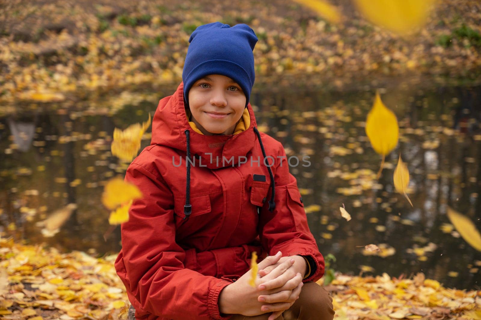 Autumn portrait of boy teen on fall nature background
