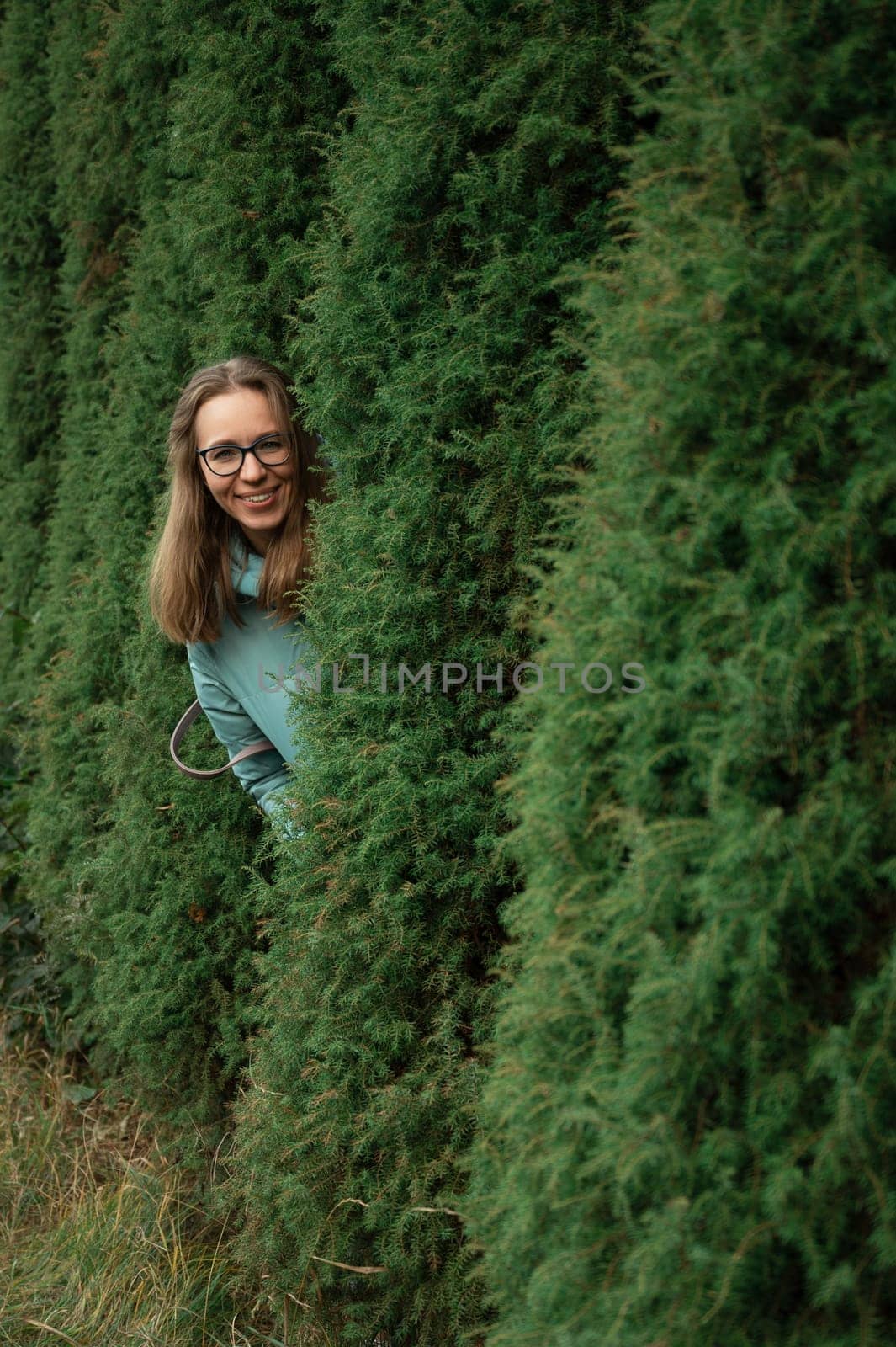 Autumn portrait of beautiful woman on thuja nature background