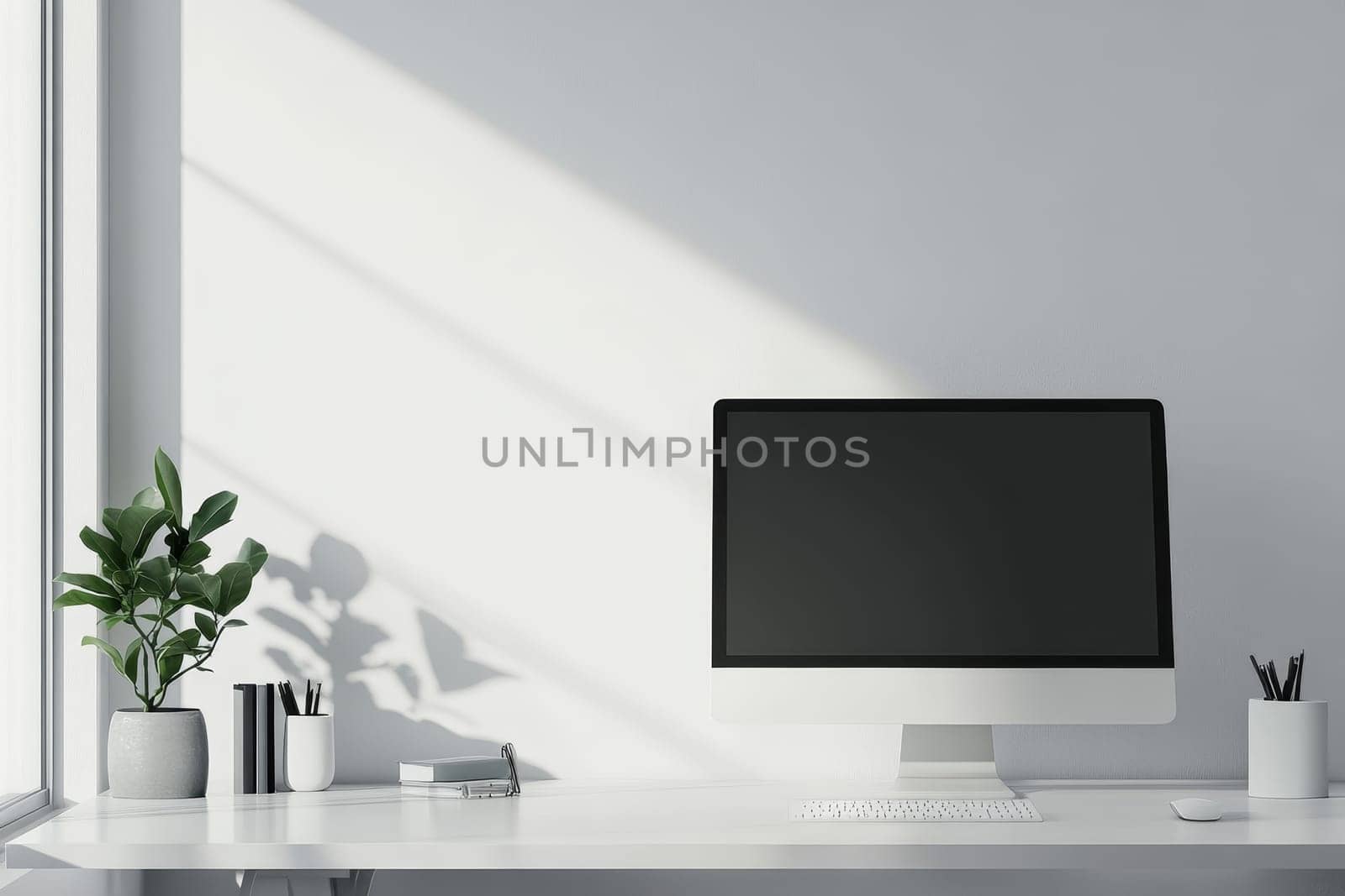 Modern workspace with desktop computer, plant, and dramatic window lighting.