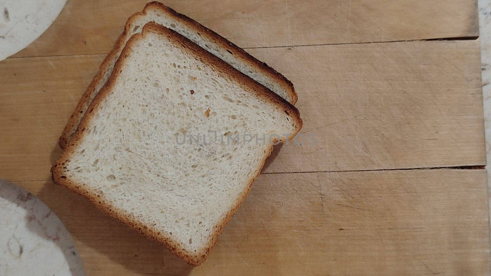 white bread sliced ​​on a wooden kitchen board baking food. High quality photo