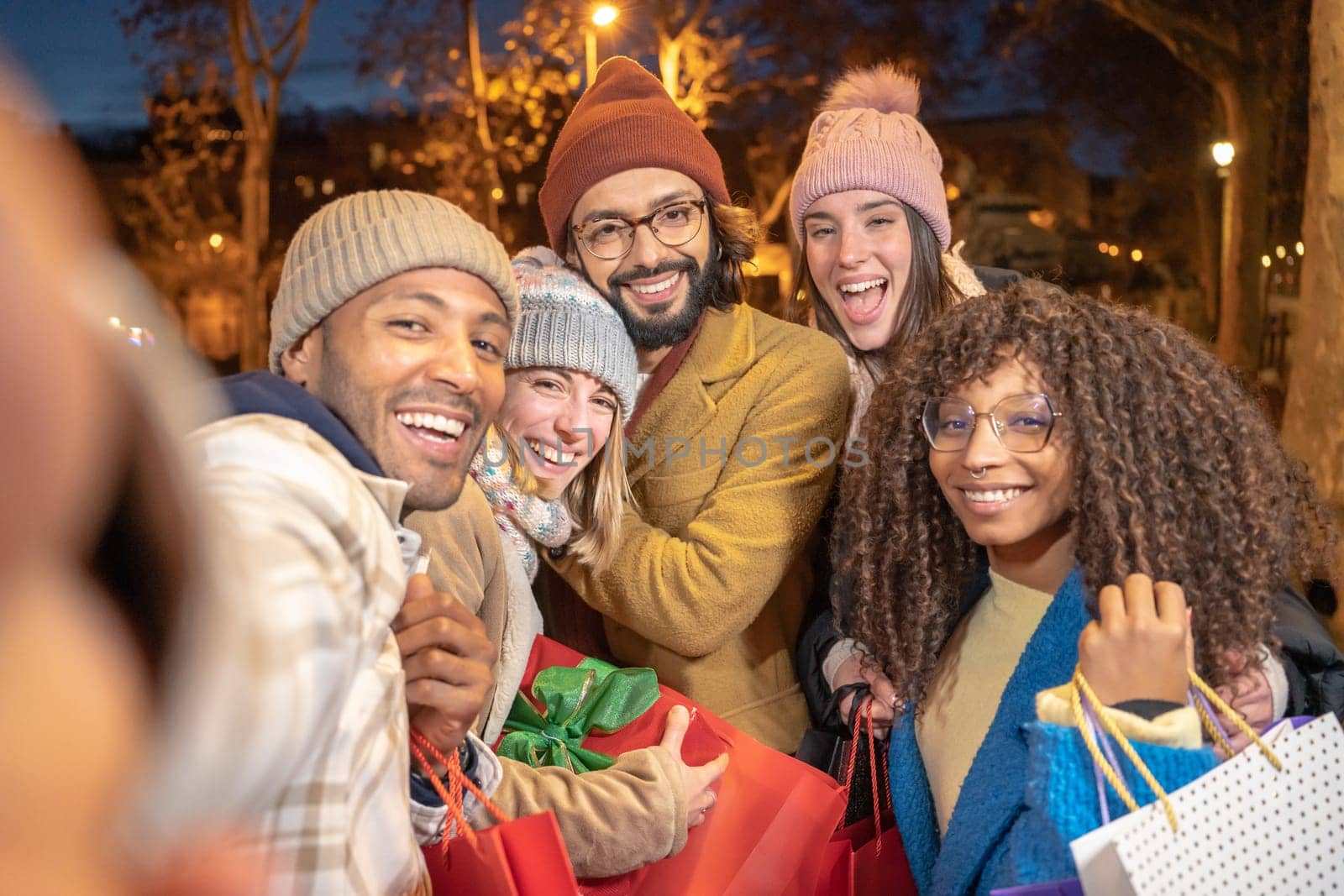Cheerful group of friends taking selfie with Christmas shopping presents. having fun together. High quality photo