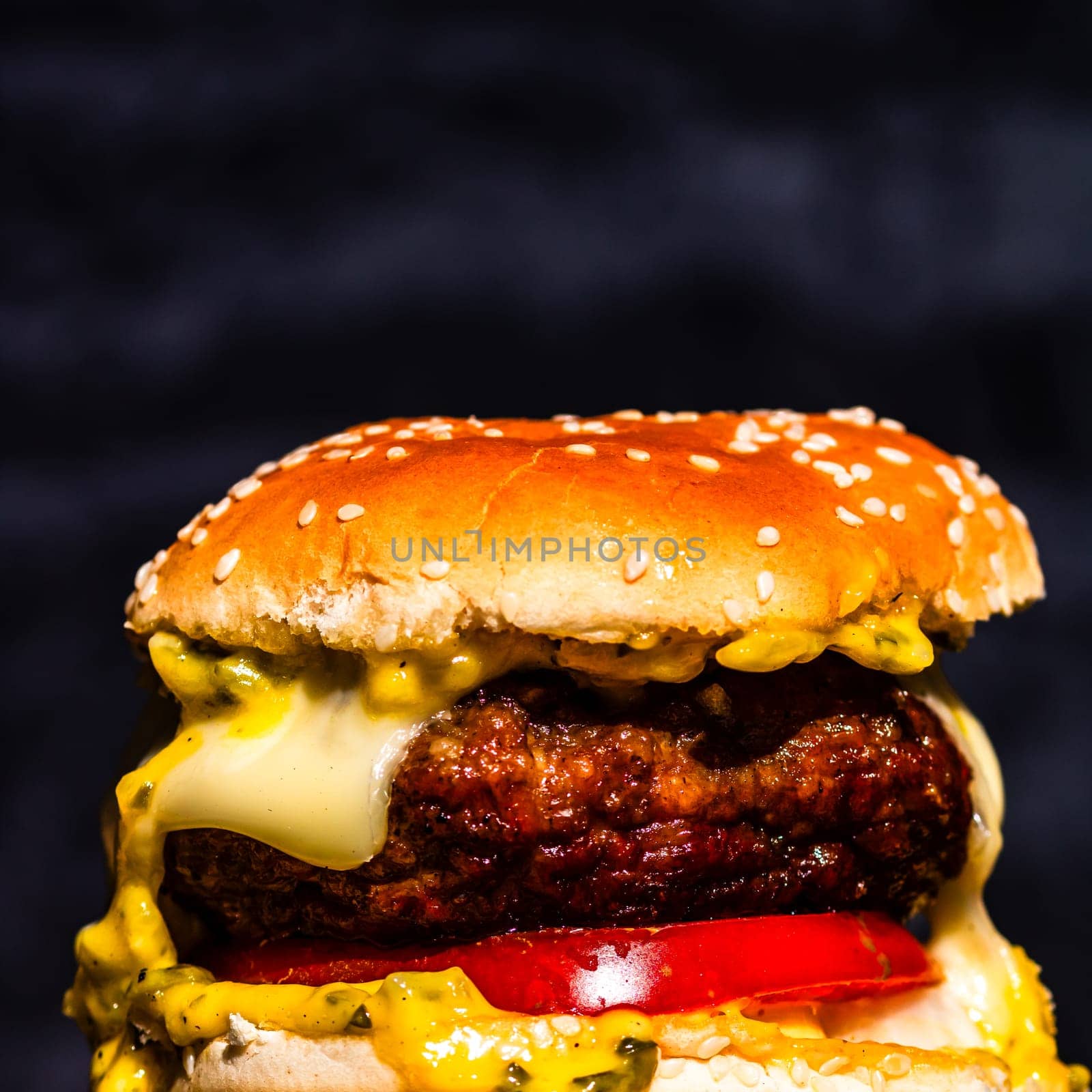 Tasty home made cheeseburger. Cheese burger with pickles, tomatoes, onion, melting cheese by vladispas