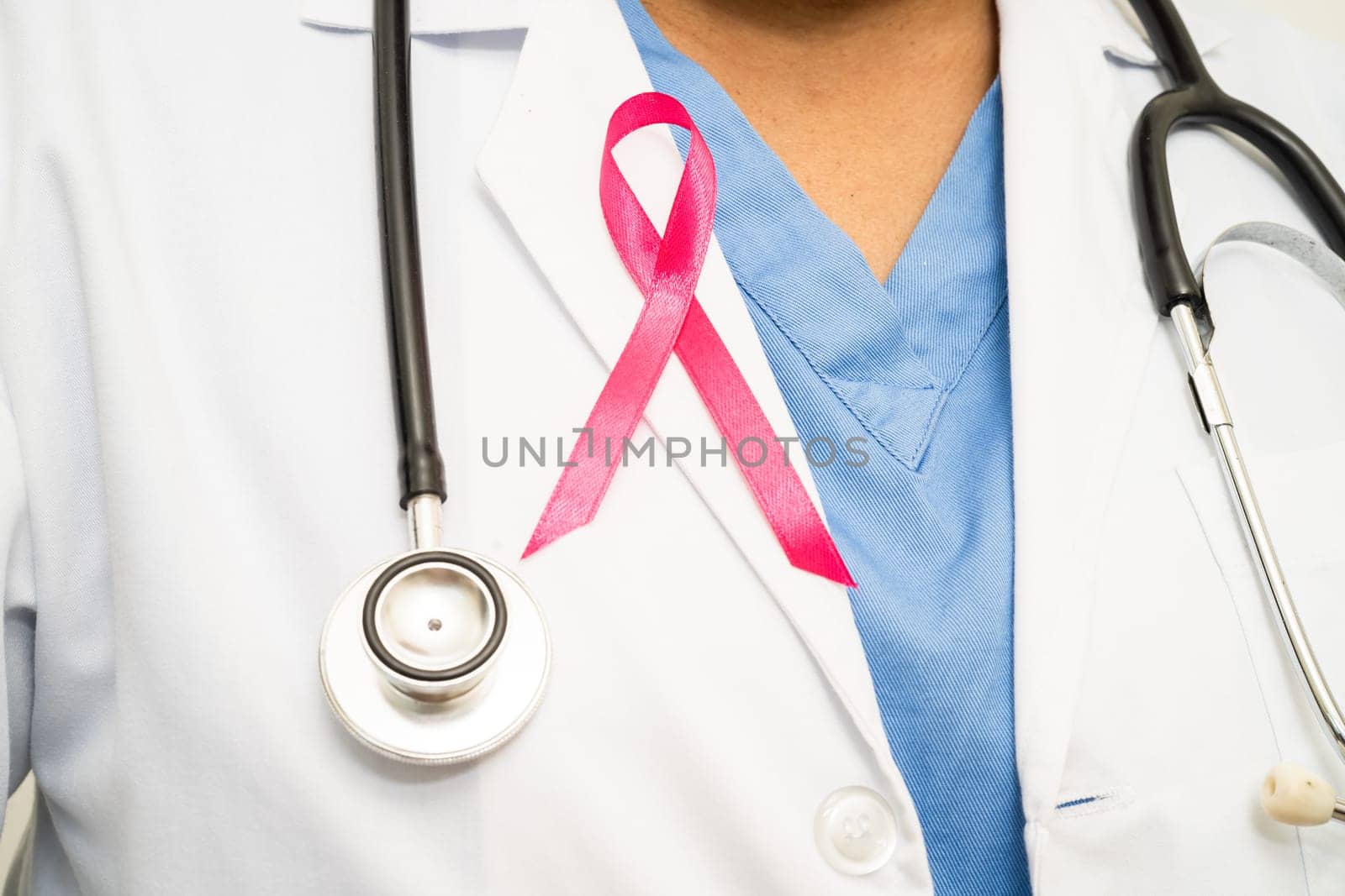 Breast cancer, Asian doctor woman with pink ribbon, symbol of World Breast Cancer Day. by pamai