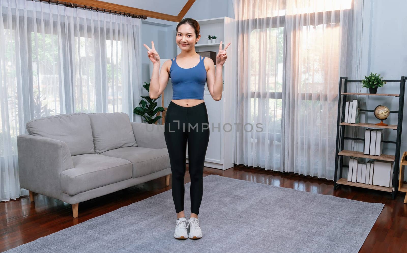 Full body asian woman in sportswear portrait, smiling and posing cheerful gesture. Home workout training with attractive girl engage in her pursuit of healthy lifestyle. Vigorous