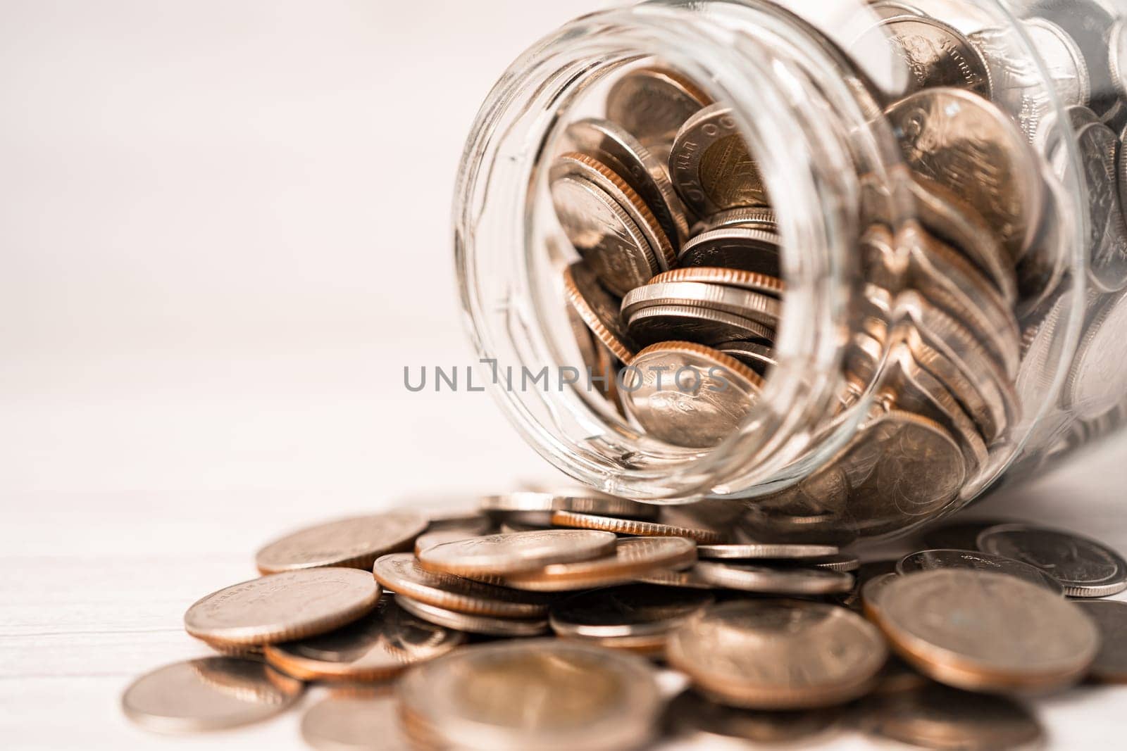 Save money coins in grass jar, Business finance investment concept.