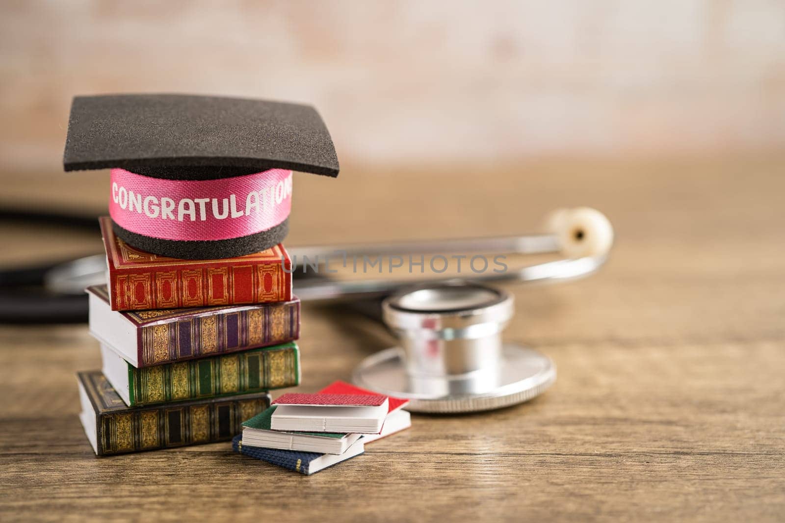 Stethoscope with graduation hat on book with copy space, learning university education concept.