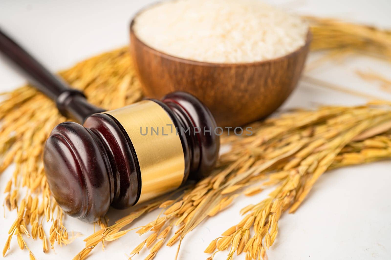 Judge gavel hammer with good grain rice from agriculture farm. Law and justice court concept. by pamai