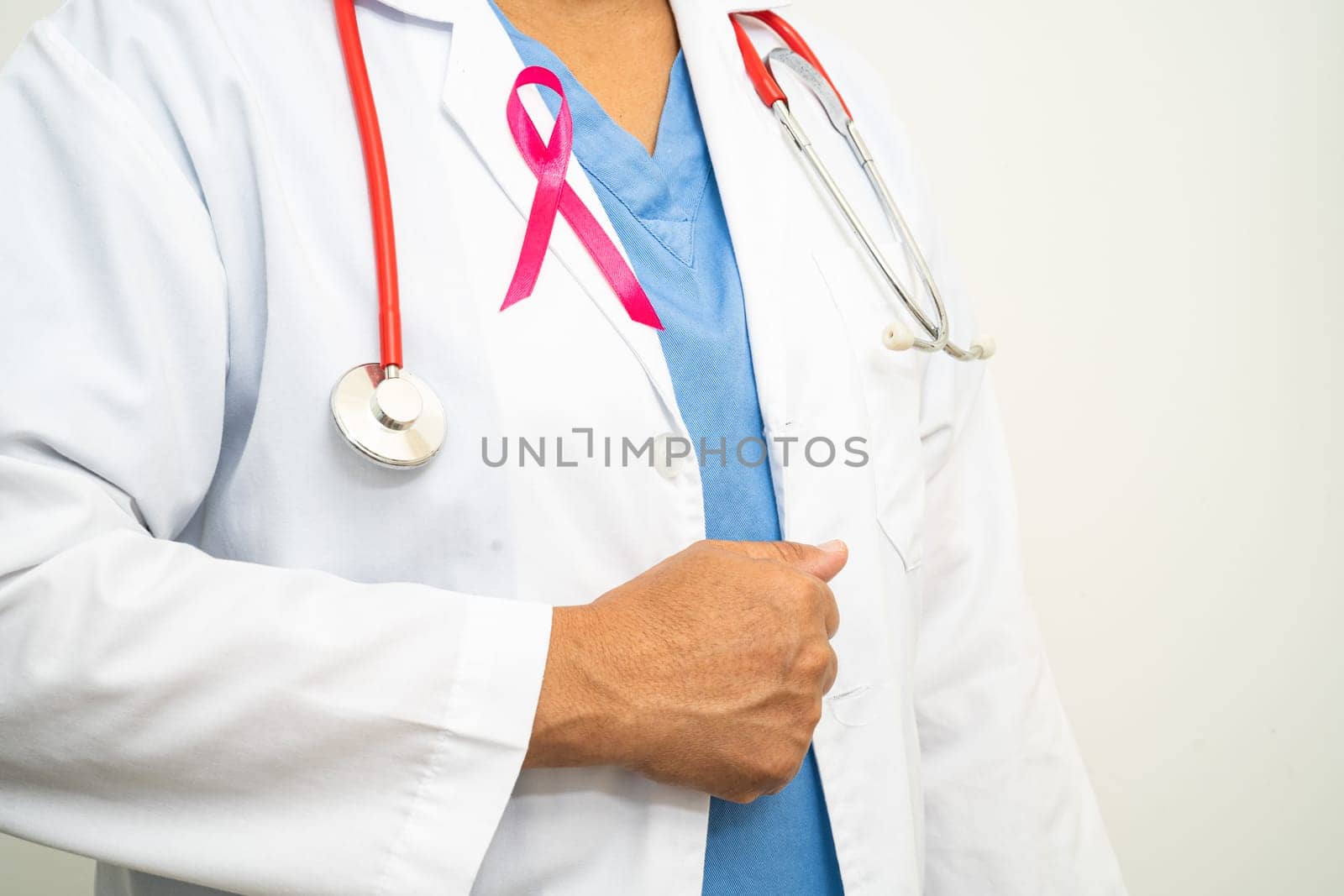 Breast cancer, Asian doctor woman with pink ribbon, symbol of World Breast Cancer Day.