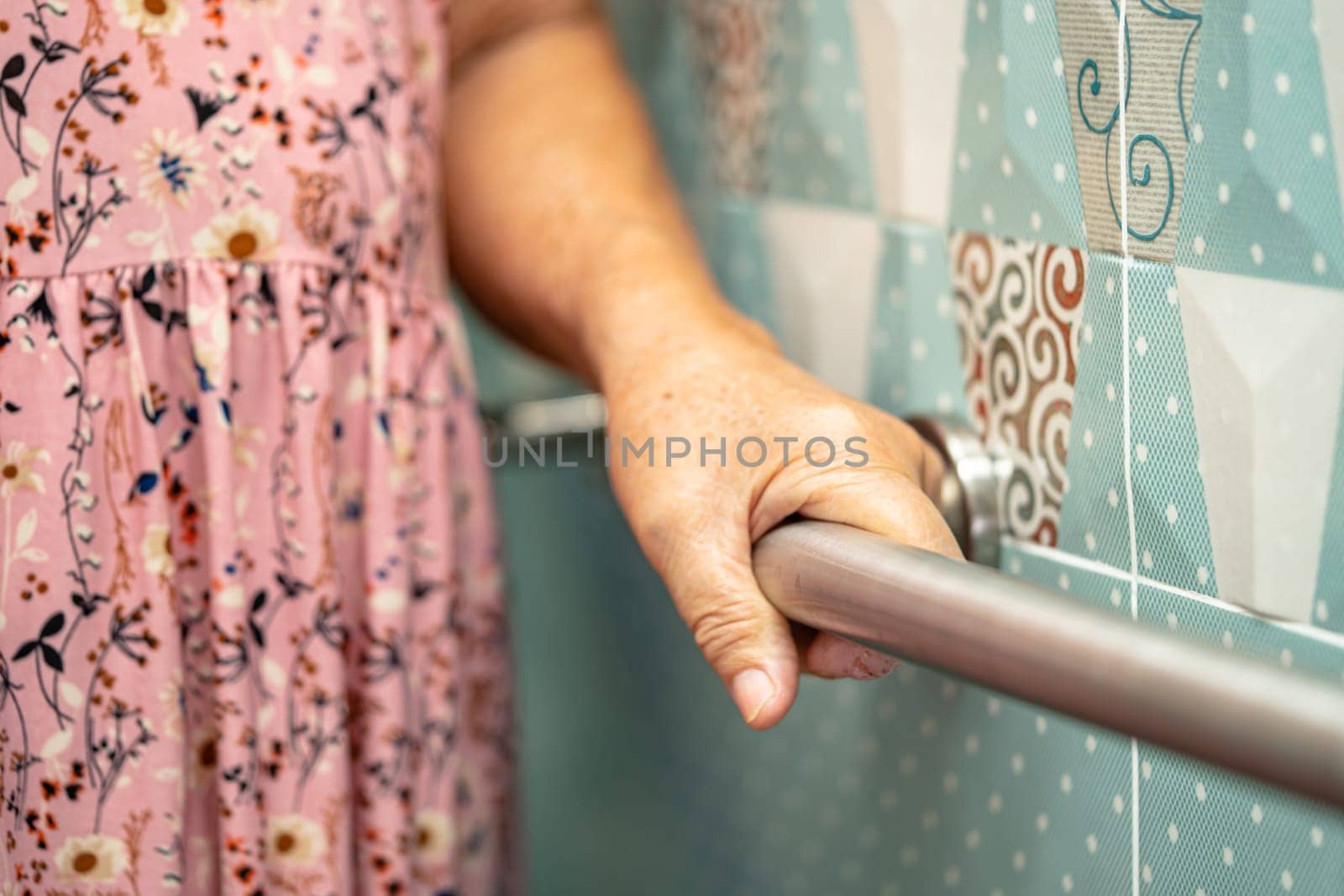 Asian elderly woman patient use toilet bathroom handle security in nursing hospital, healthy strong medical concept.