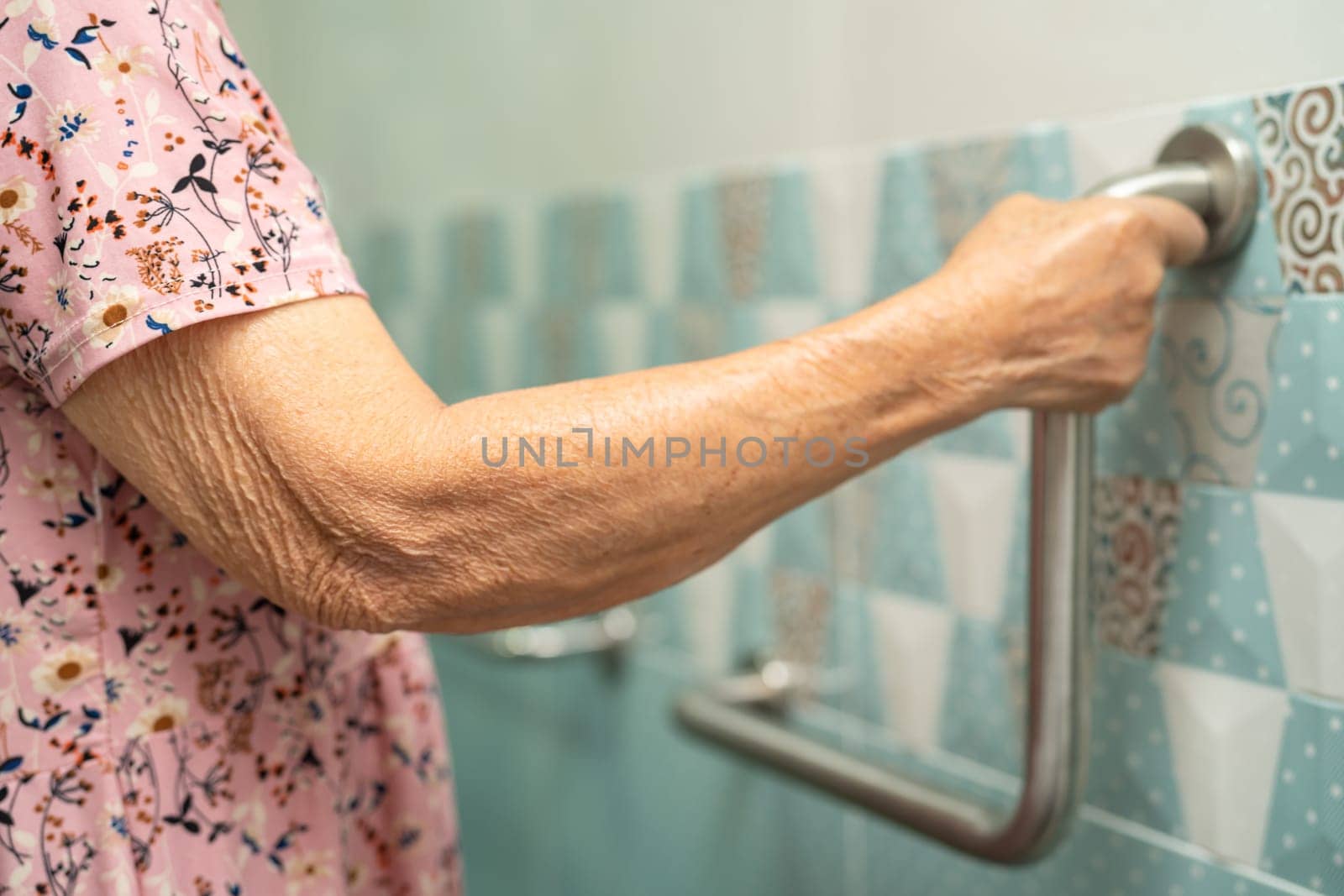 Asian elderly woman patient use toilet bathroom handle security in nursing hospital, healthy strong medical concept. by pamai