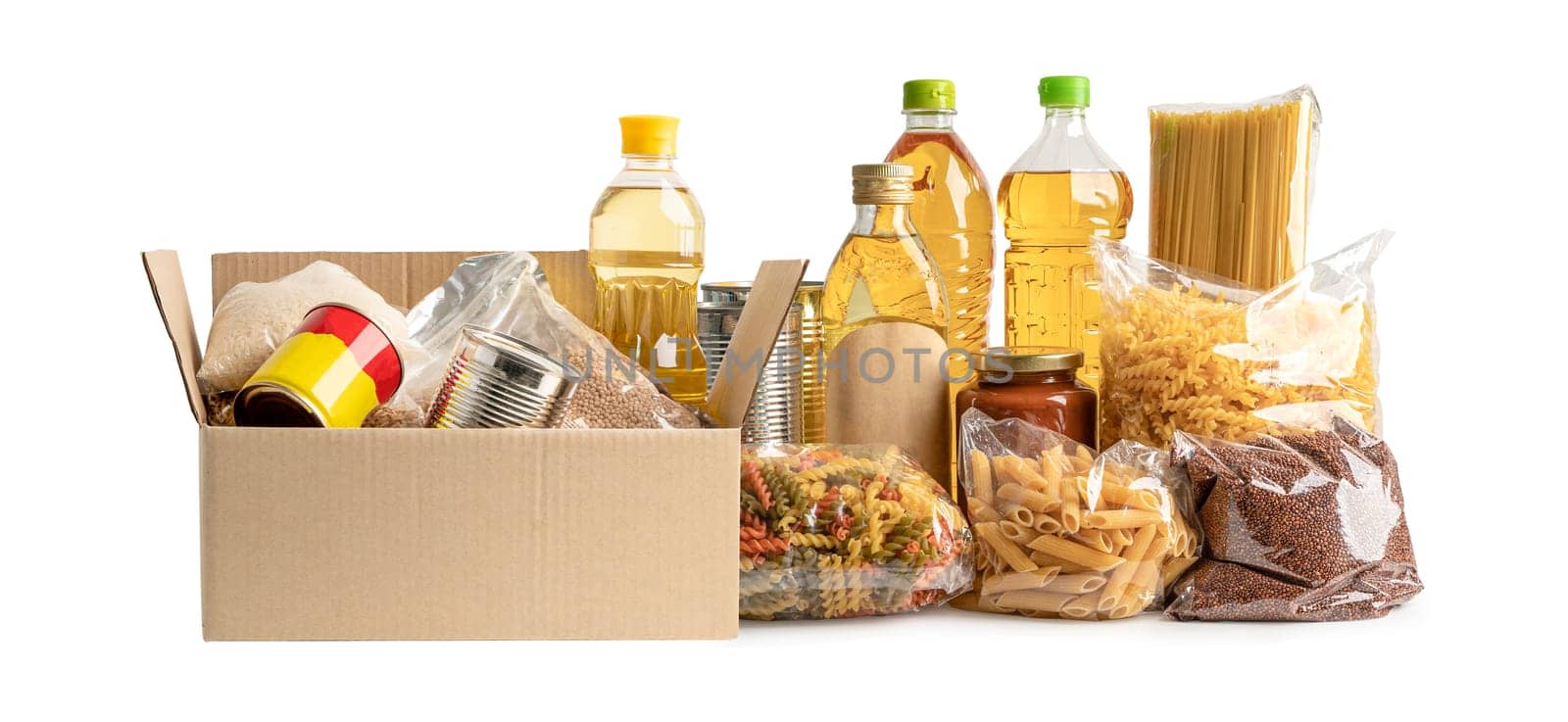 Foodstuff for donation, storage and delivery. Various food, pasta, cooking oil and canned food in cardboard box. by pamai