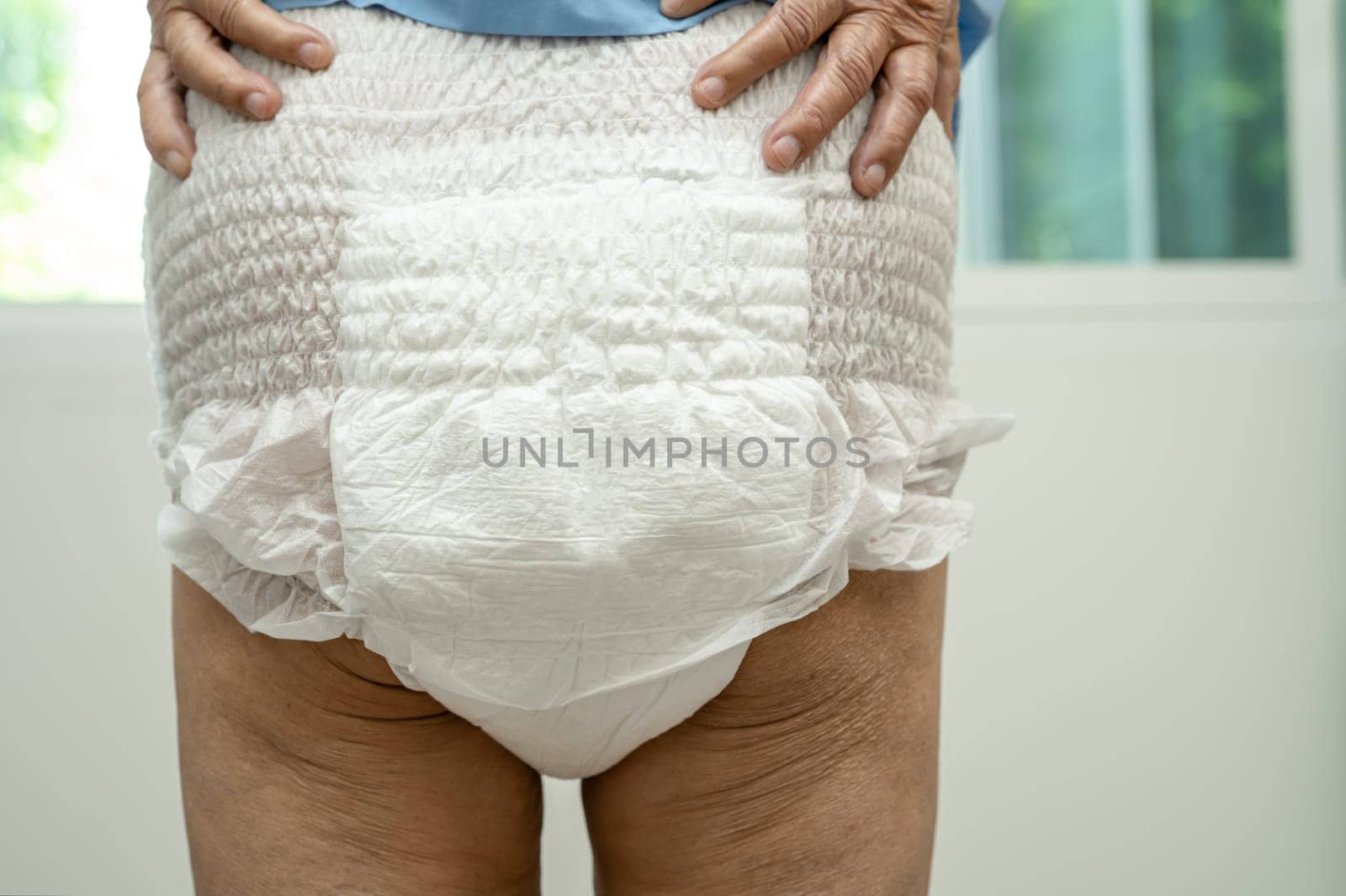 Asian senior woman patient wearing incontinence diaper in hospital, healthy strong medical concept.