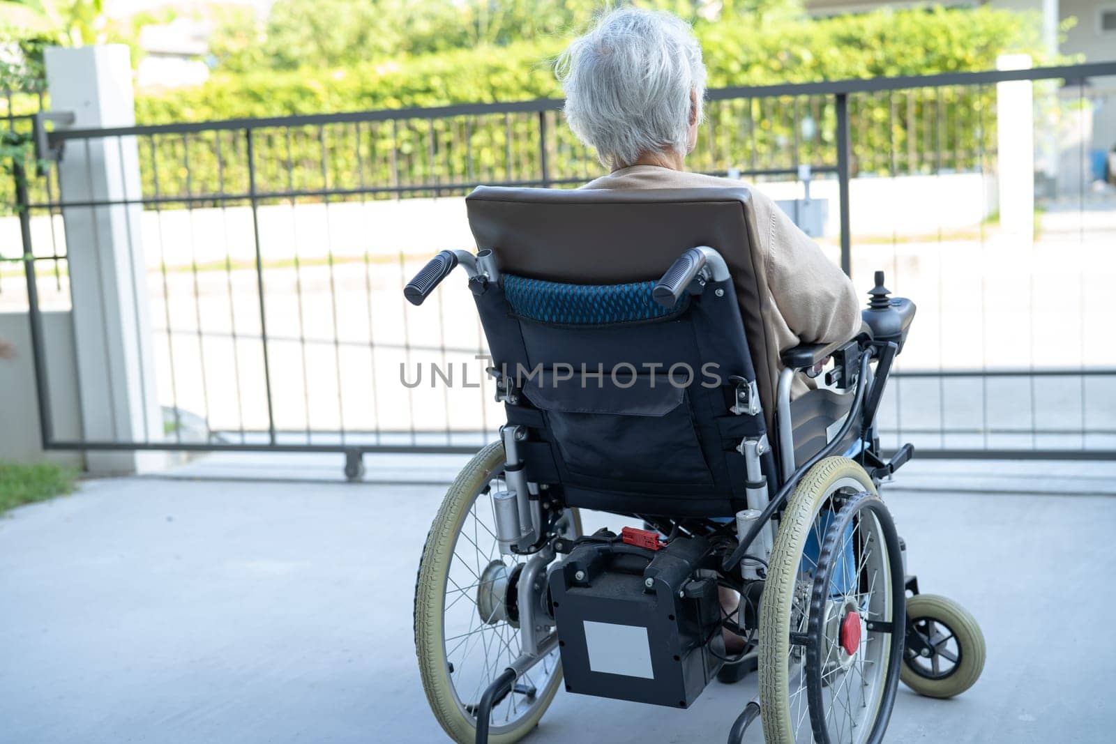 Asian senior woman patient on electric wheelchair, healthy strong medical concept. by pamai