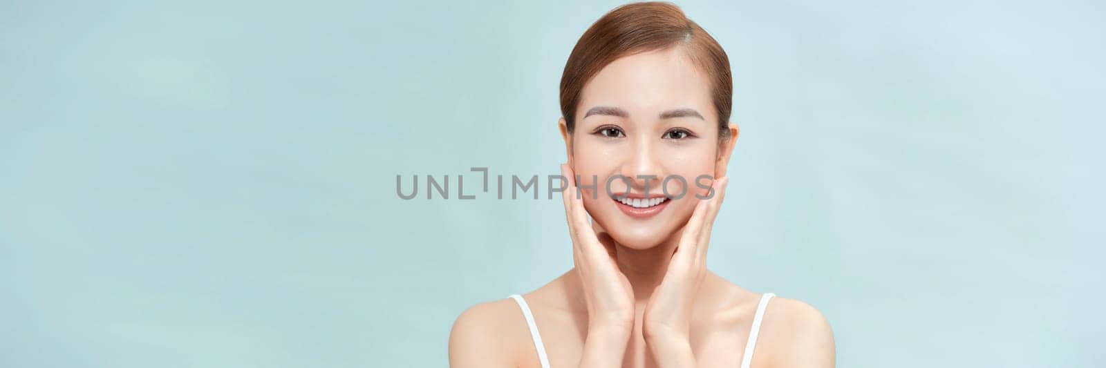 A smiling woman clean fresh face isolated on pastel background, banner