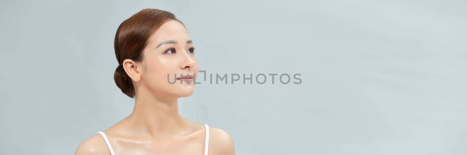 Portrait of nice young gorgeous woman on blue pastel back. Banner, lots of copyspace