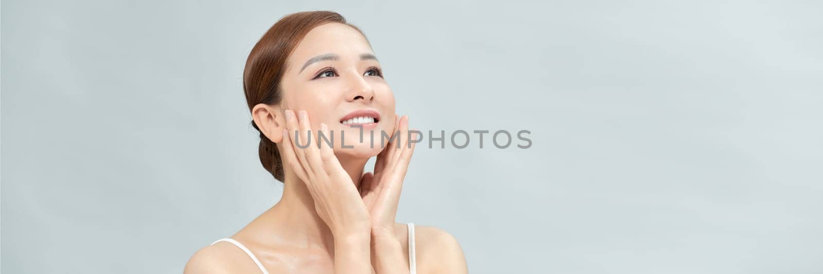 Portrait of beautiful female model on blue light background by makidotvn