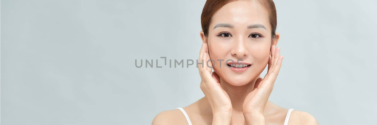 Banner with happy Asian female face with natural skin on white background by makidotvn