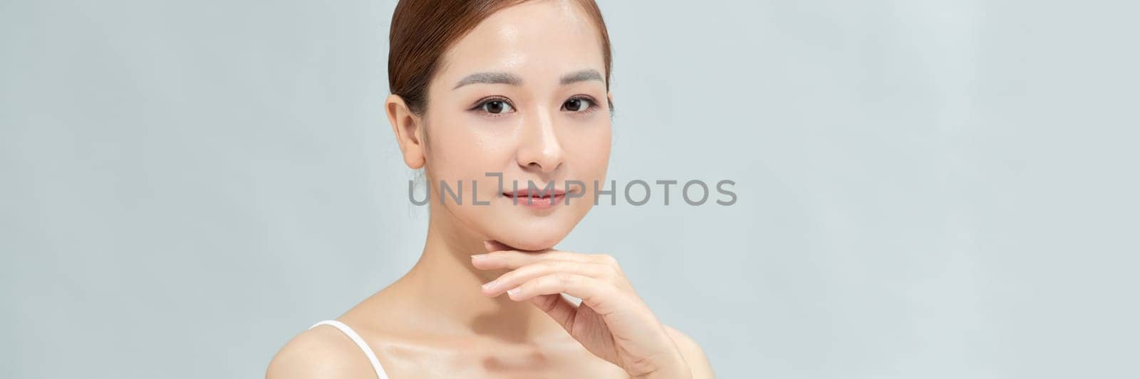 Portrait of nice young gorgeous woman on blue pastel back. Banner, lots of copyspace