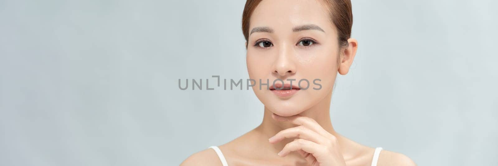Woman with beautiful face touching healthy facial skin portrait on banner background