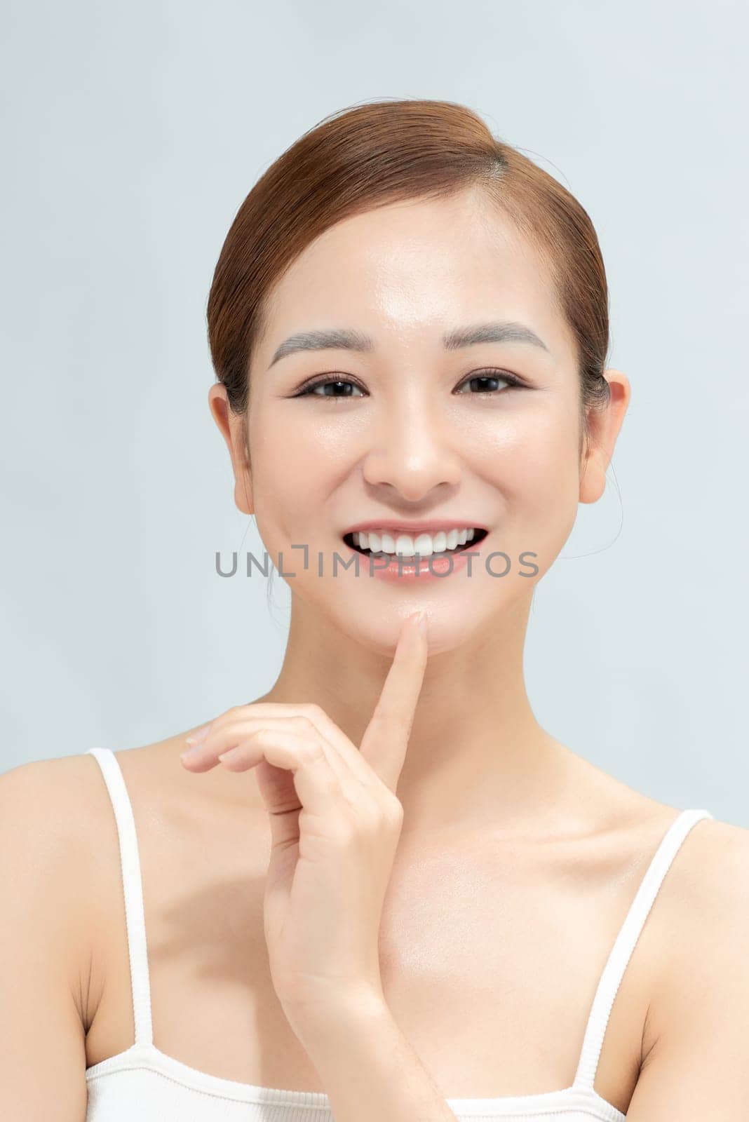 Woman with beautiful face touching healthy facial skin portrait on banner background by makidotvn