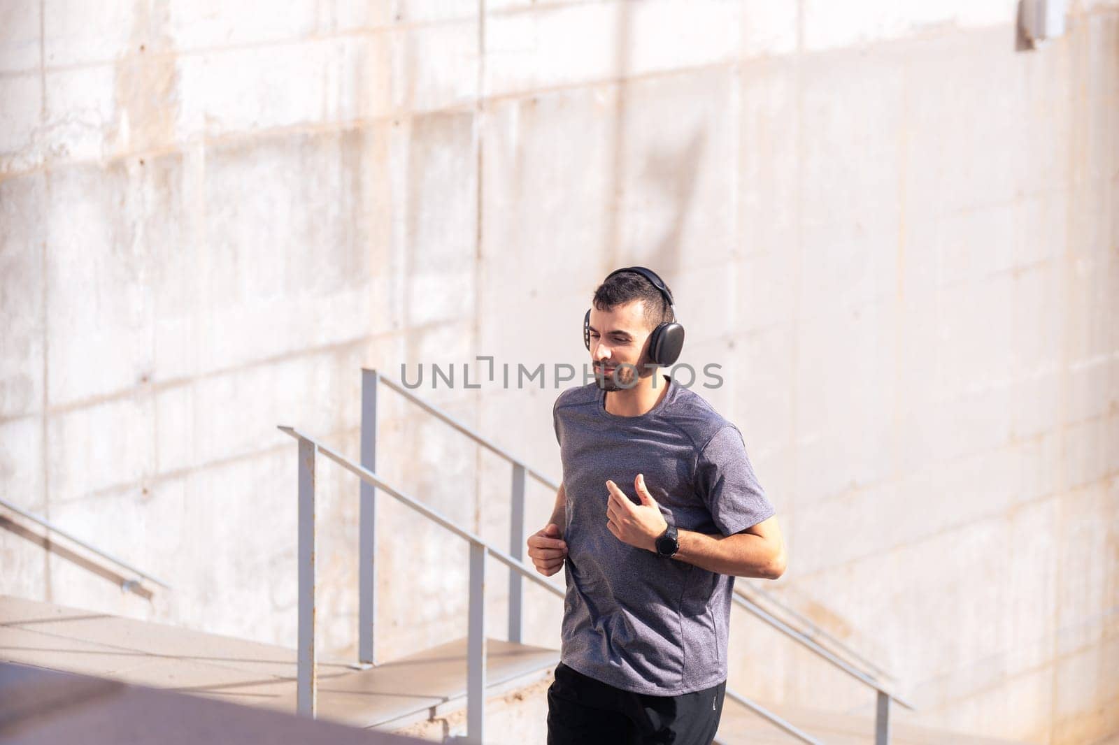 Man running down the stairs doing his daily cardio and warm-up exercise. Physical Activity Concept
