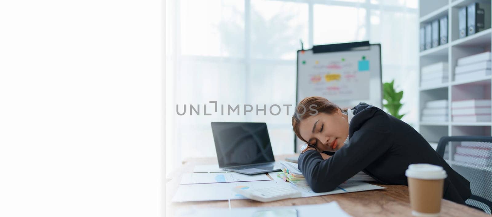 businesswoman plans a finance audit, reviewing documents while battling burnout syndrome