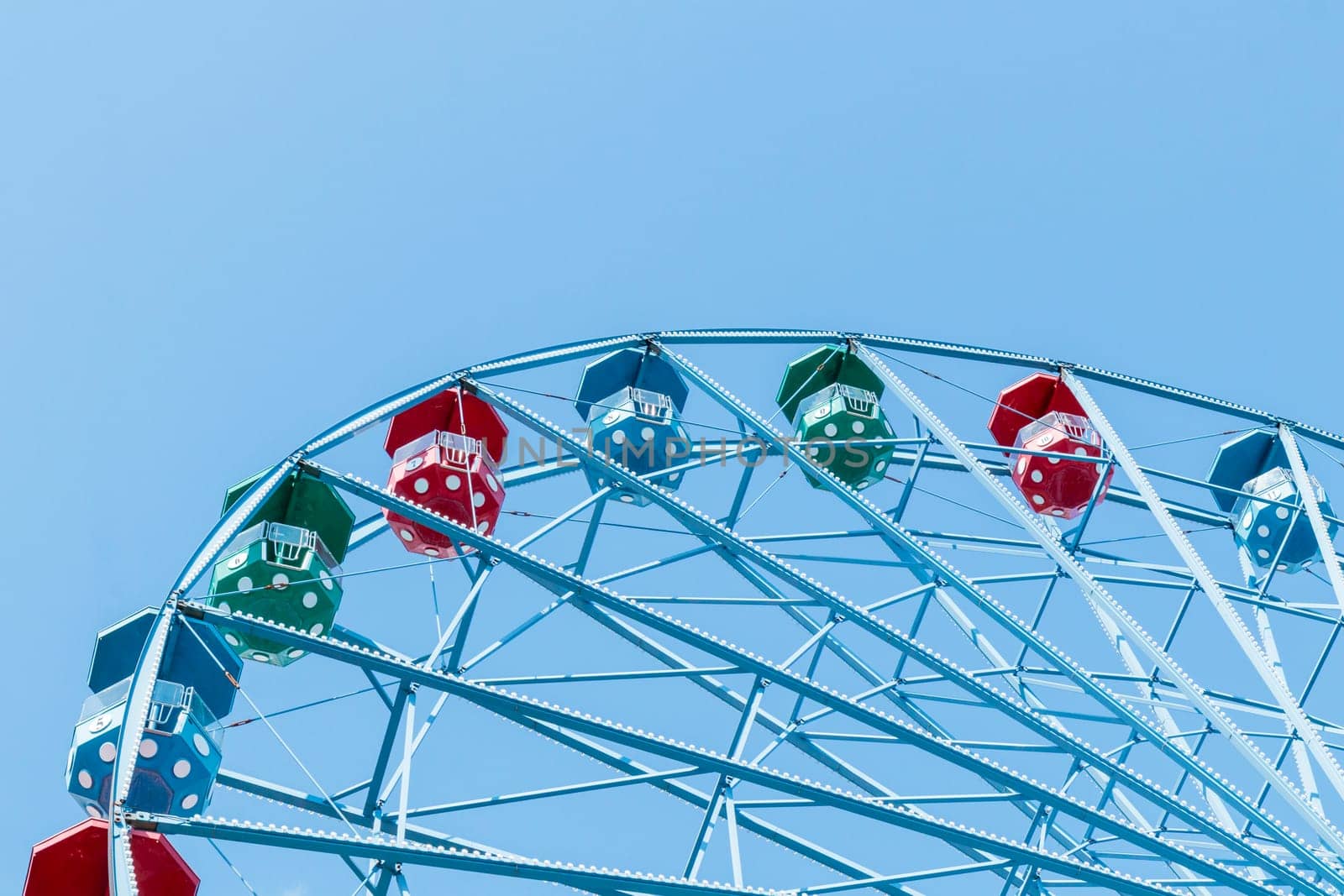 Helsinki, Finland - 19 AUGUST 2024: Linnanmaki amusement park. Ferris wheel Rinkeli, blue sky on a background