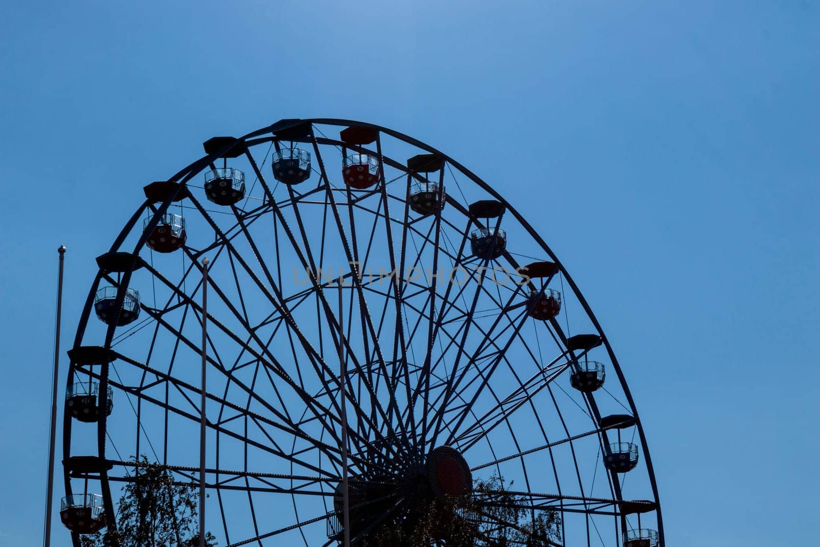 Helsinki, Finland - 19 AUGUST 2024: Linnanmaki amusement park. Ferris wheel Rinkeli, blue sky on a background