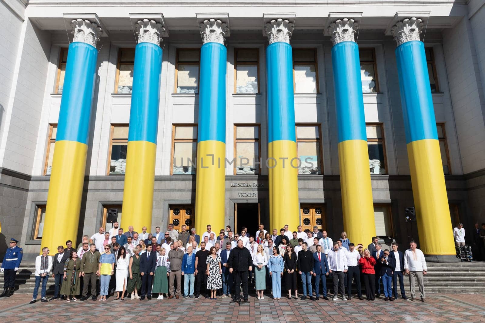 KYIV, UKRAINE - Aug. 23, 2024: A solemn ceremony near the Verkhovna Rada on State Flag Day. A group of parliamentarians during the ceremonial raising of the Ukrainian national flag