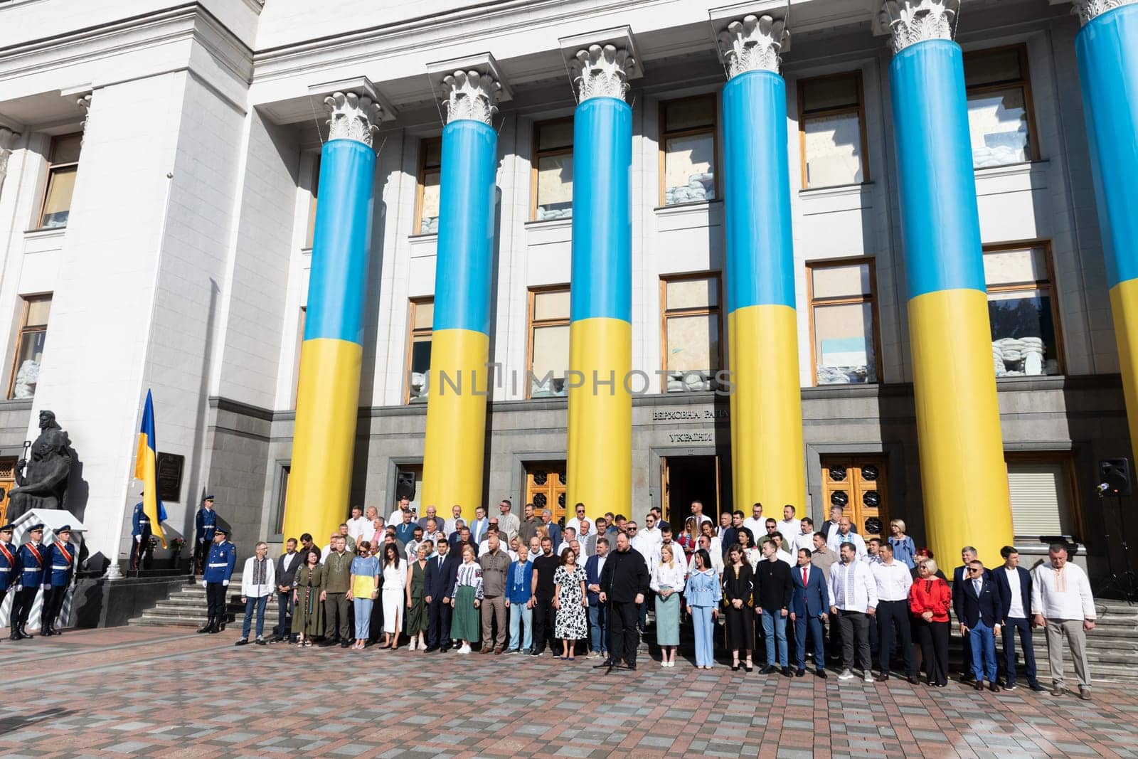 KYIV, UKRAINE - Aug. 23, 2024: A solemn ceremony near the Verkhovna Rada on State Flag Day. A group of parliamentarians during the ceremonial raising of the Ukrainian national flag
