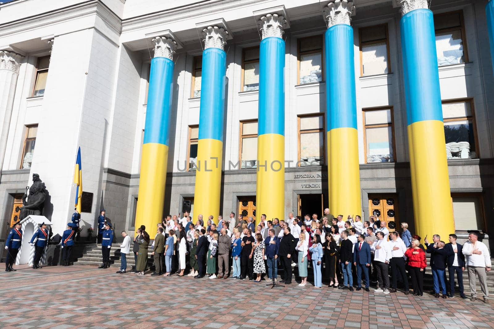 KYIV, UKRAINE - Aug. 23, 2024: A solemn ceremony near the Verkhovna Rada on State Flag Day. A group of parliamentarians during the ceremonial raising of the Ukrainian national flag