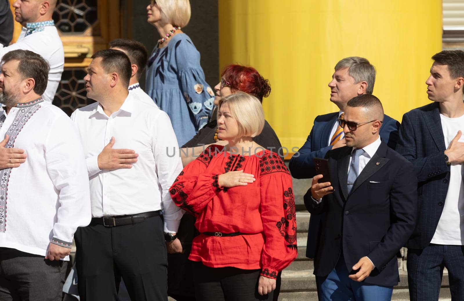 KYIV, UKRAINE - Aug. 23, 2024: A solemn ceremony near the Verkhovna Rada on State Flag Day. A group of people's deputies during the flag-raising ceremony and singing of the national anthem