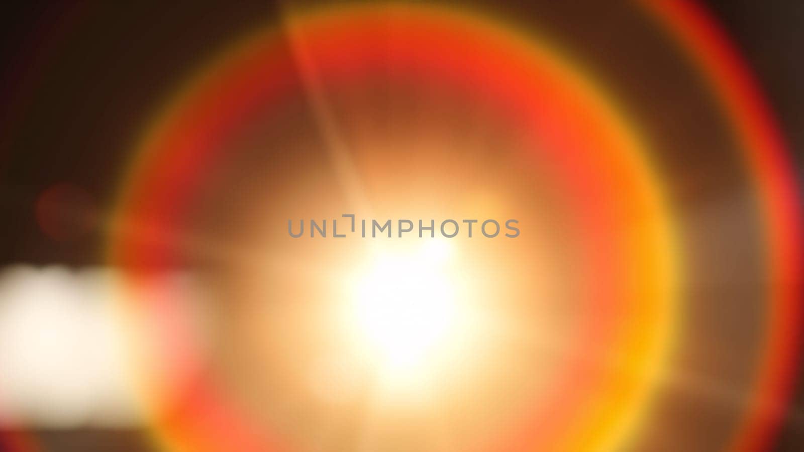 Light pours from a warm, bright rainbow in blur on a black background with a dusty texture. Use this defocused, abstract, damaged, scratched, retro cinema analog effect as a screen filter or overlay for image. High quality photo