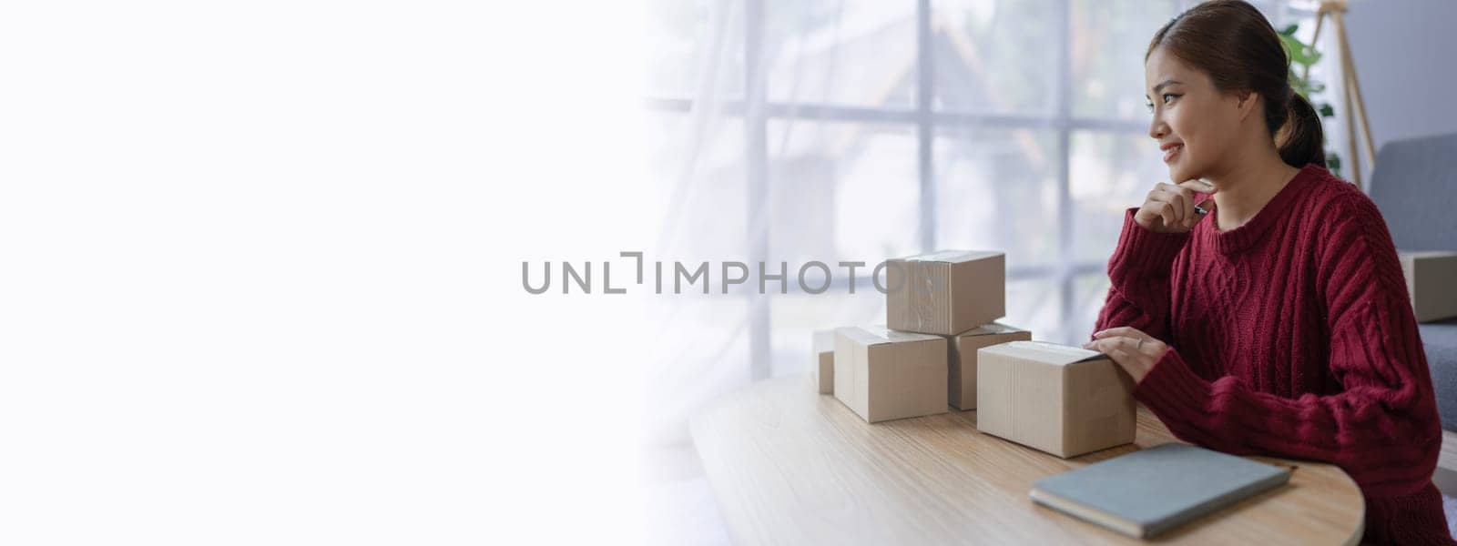 woman, online seller, efficiently manages customer orders and delivery through the e-commerce platform.