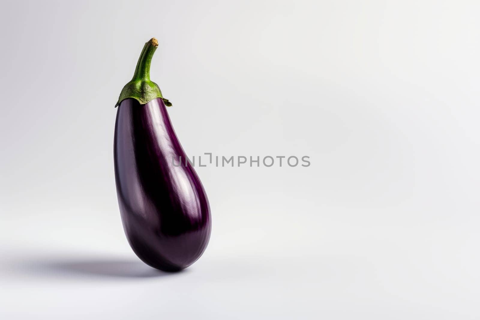 Ripe eggplant on a bright background. Minimalism.