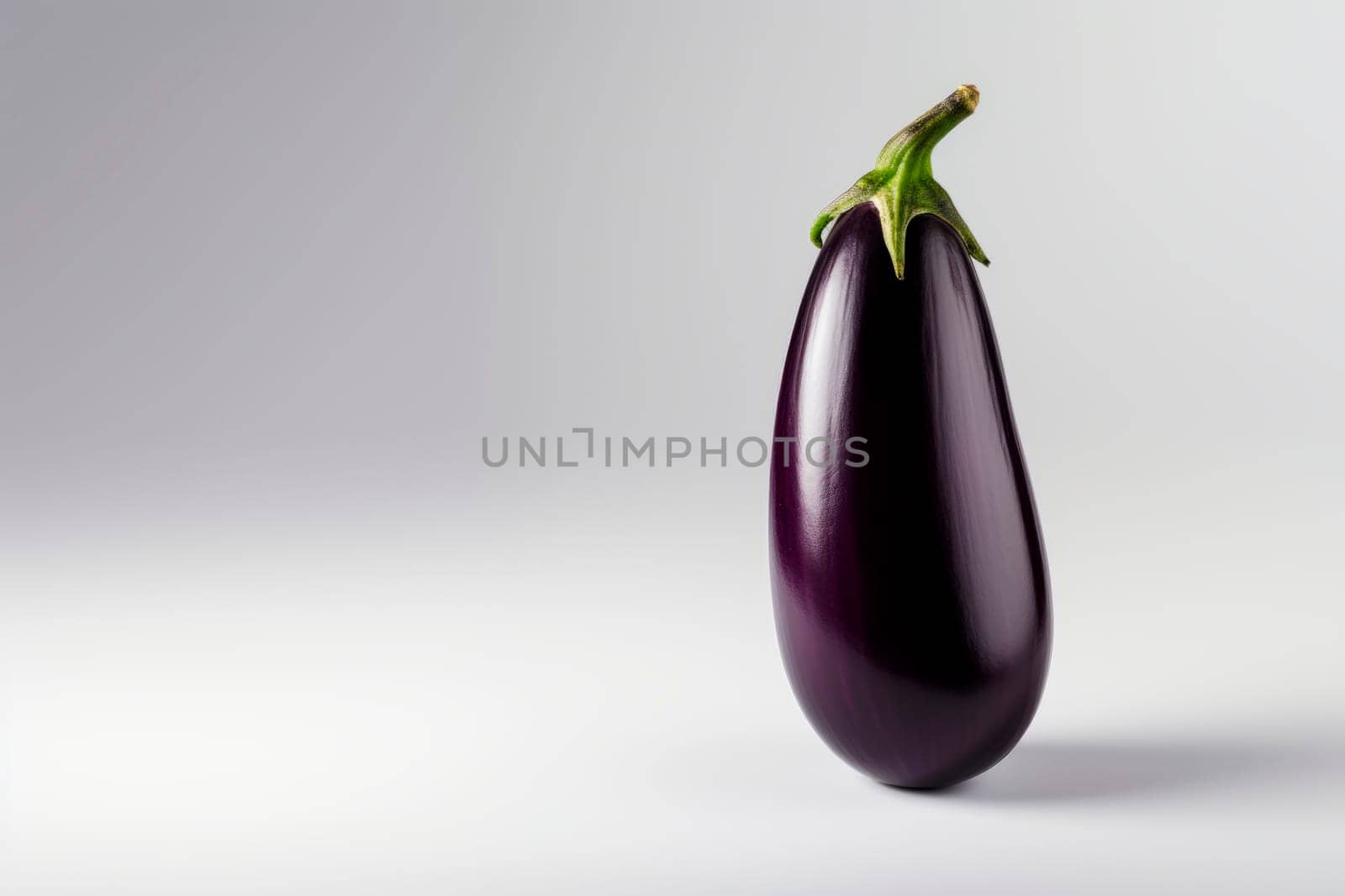 Ripe eggplant on a bright background. Minimalism.