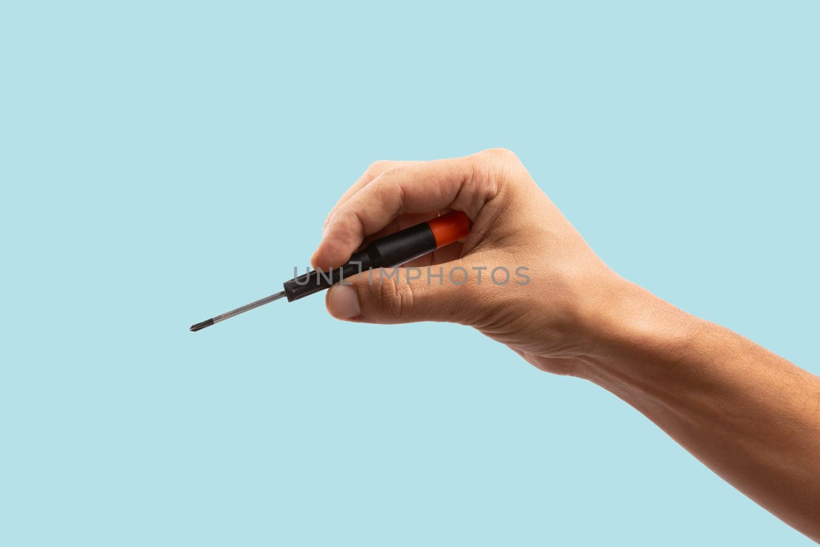 Black male hand holding a screwdriver for repair isolated on cyan background by TropicalNinjaStudio