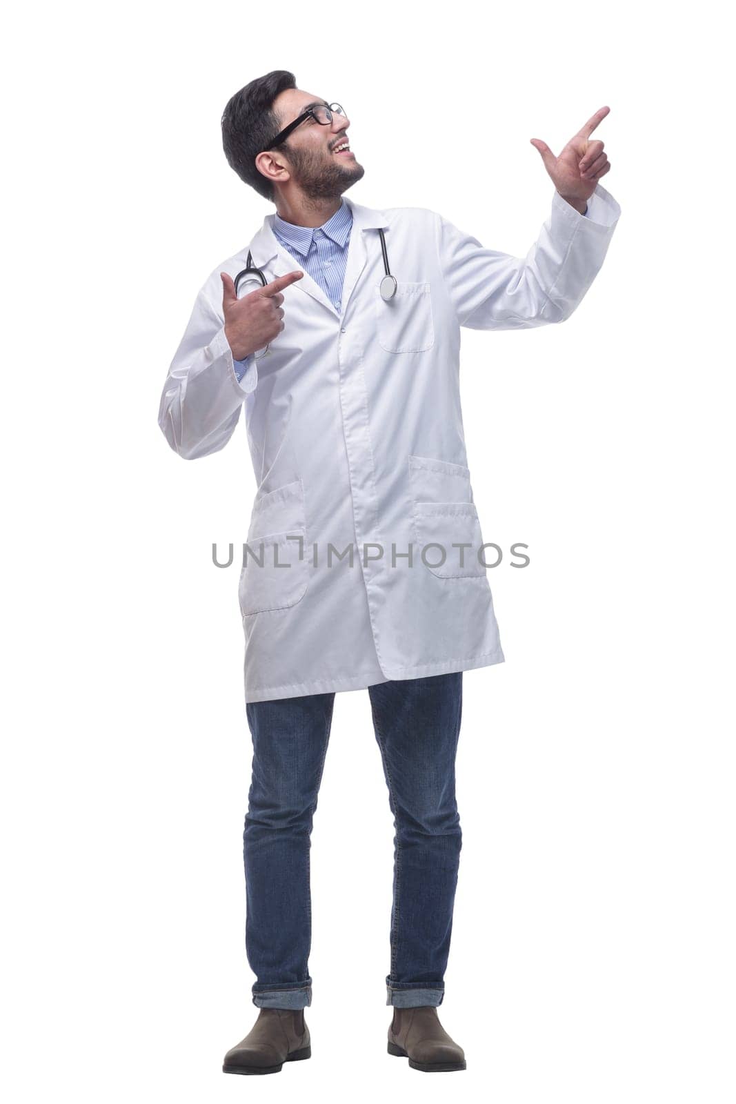 in full growth. thoughtful doctor looking at a white blank screen . isolated on white background.