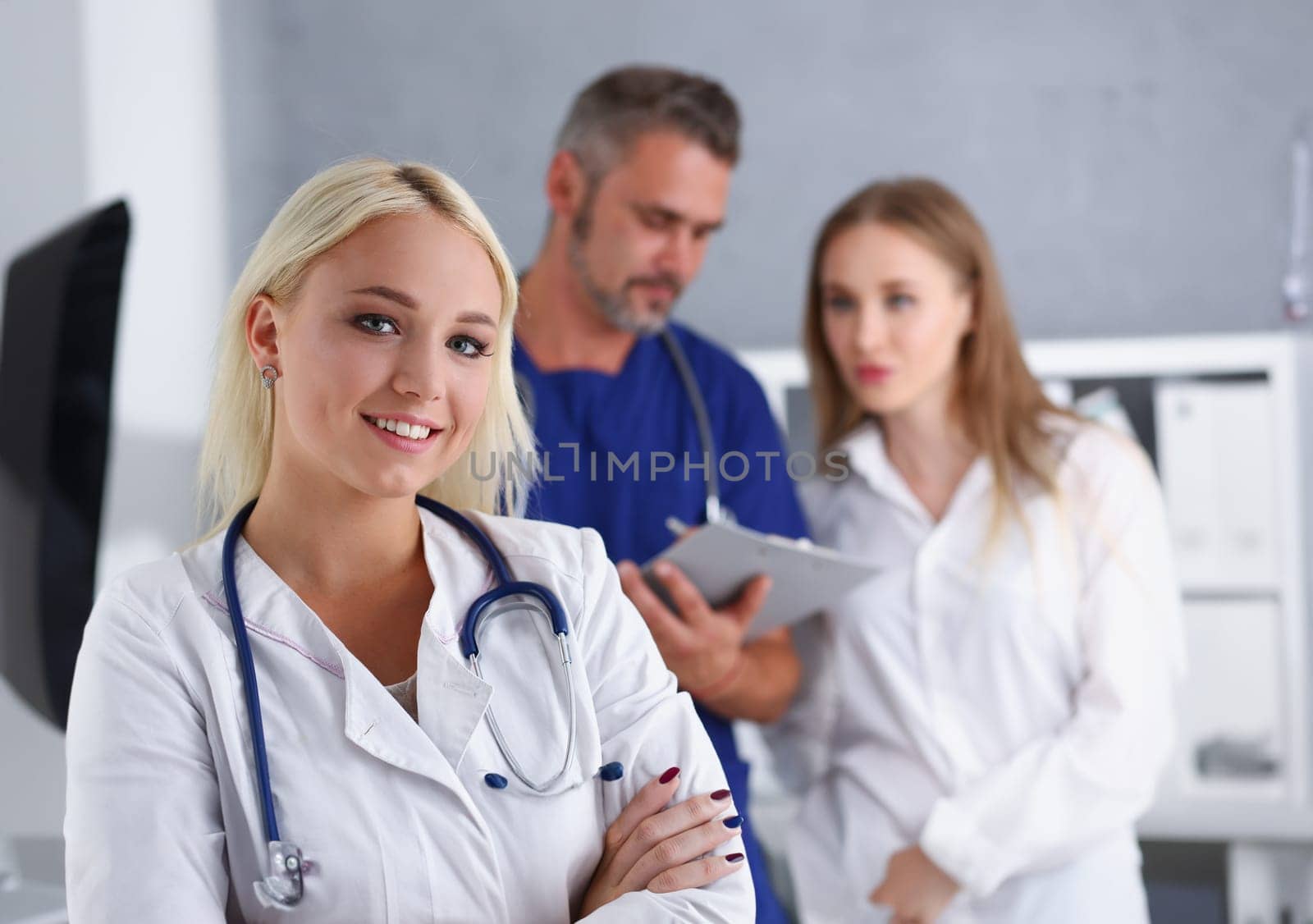 Beautiful smiling female doctor stand in office by kuprevich