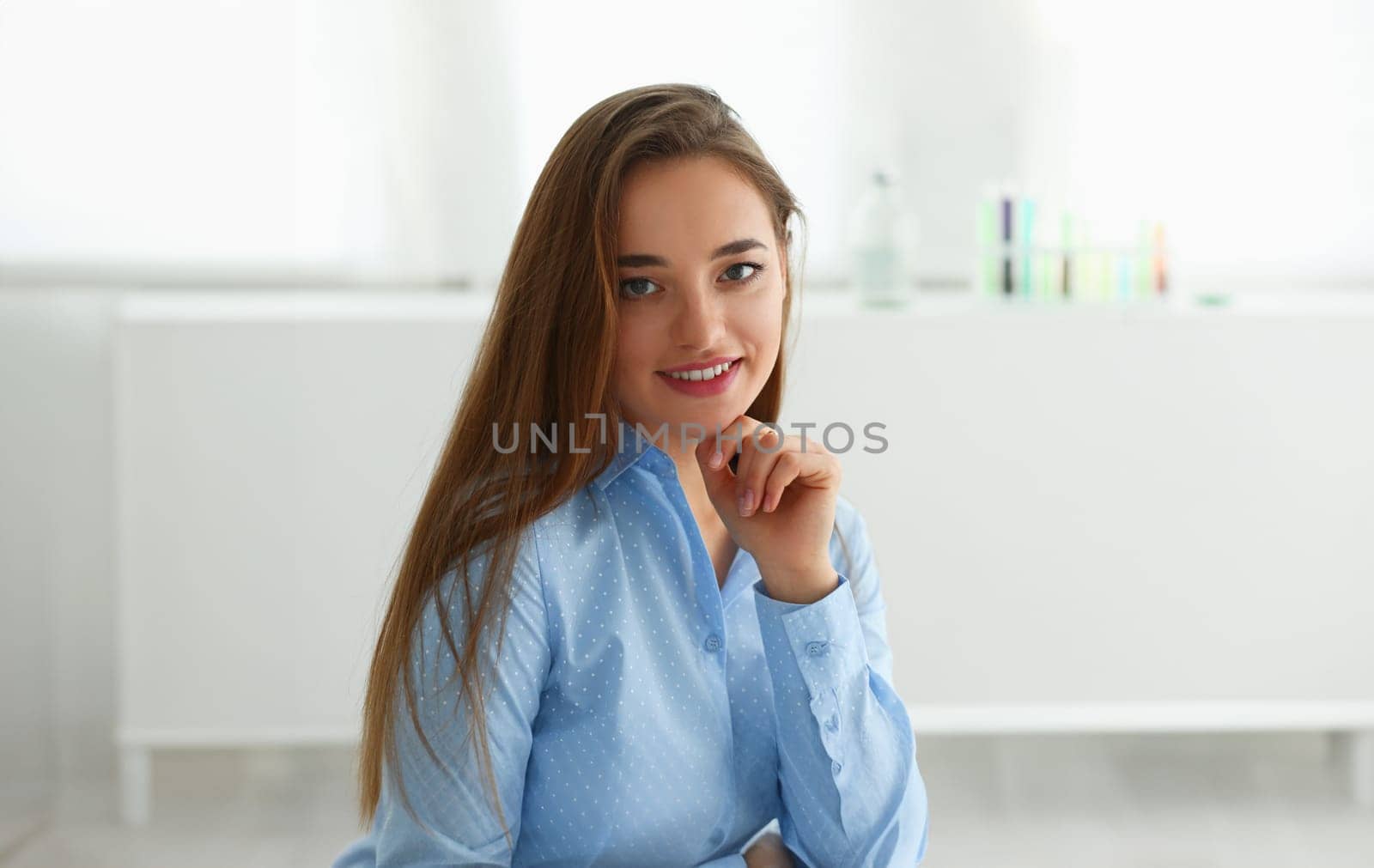 Cute female portrait looking in camera at workplace in office. White collar worker at workspace job offer modern life style concept
