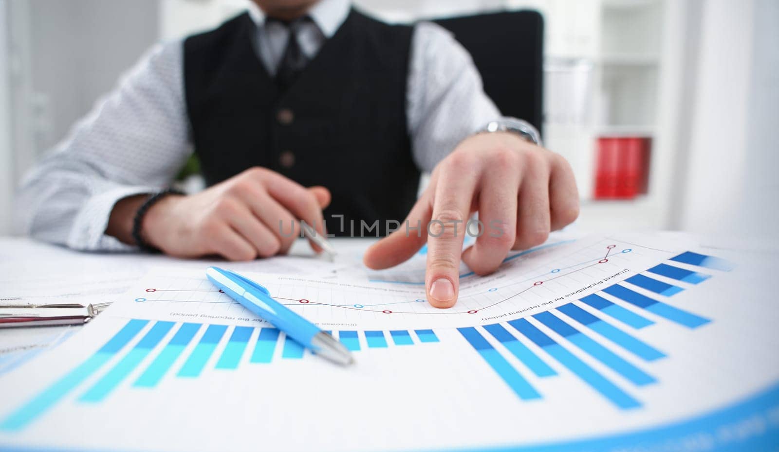 Male arm hold silver pen and point finger in financial graph solve and discuss problem closeup. Fresh view at situation board council sale adviser examine advisor profit audit job market irs concept