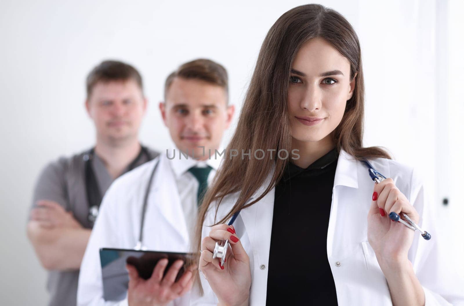 Group of medics proudly posing in row and looking in camera smiling. High level service, best treatment 911 professional healthy lifestyle therapeutist consultation physical emergency concept