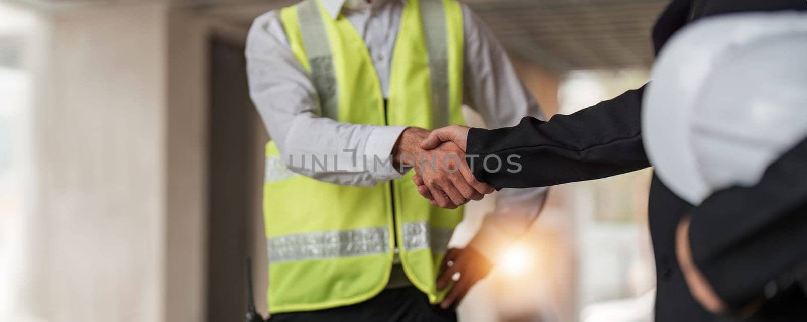 Hand in hand between project contractors and customers due to negotiation of expenses and investments, construction and repair of residential buildings. by wichayada